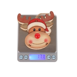 Detail view of cute wooden reindeer Christmas ornament on a scale weighing 17.1 grams