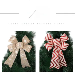 Detail of Christmas bows with snowflake print and red wavy stripes on a festive tree