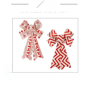 Close-up of red Christmas bows with reindeer snowflake patterns and glitter details