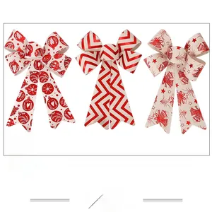 Detailed view of three burlap Christmas bows with festive red patterns and long ribbons
