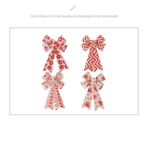 Detailed close-up of four red and cream Christmas bows with reindeer and star patterns
