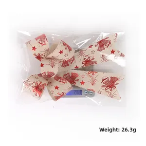 Christmas bow decoration with red bells and stars on beige linen fabric weighing 26.3g