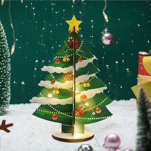 Detail of DIY wooden 3D Christmas tree with LED lights and festive star topper on faux snow