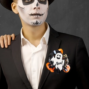 Halloween ghost badge with sequins and black tassels worn on a black suit lapel