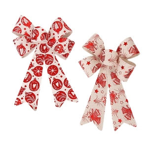 Christmas burlap bow ornaments with red festive bells and snowflake prints for gift wrapping