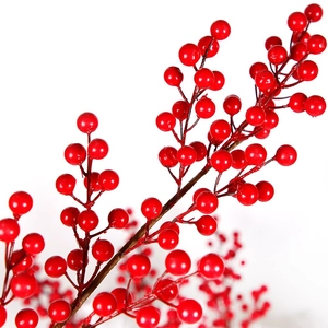 Macro shot of artificial red berry stems with realistic glossy finish on white backdrop