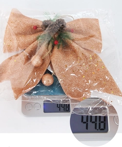 Macro view of Christmas bow ornament weighing 44.8g with pine cones and rose gold sequins