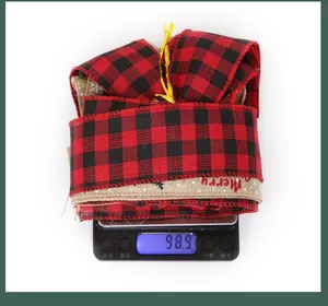 Close-up of Christmas buffalo plaid ribbon showing weight on scale and Merry text print