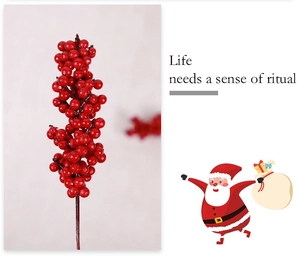 Close-up of artificial red berries for Christmas wreaths and DIY floral holiday decor
