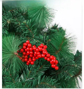 Close-up of artificial red berries and green pine needles for Christmas decoration