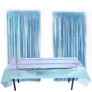 Close-up of light blue metallic foil tablecloth with matching tinsel fringe curtains
