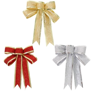 Three glittering Christmas bows in gold, red and silver for holiday tree decoration