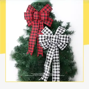 Close-up of red and white plaid ribbon bows on a Christmas tree branch
