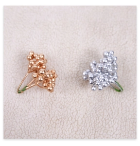 Detail of glittered mini gold and silver foam berries for Christmas tree decoration