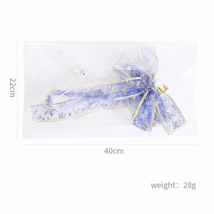Detail showing blue ribbon bow with golden snowflakes and dimensions 22cm by 40cm