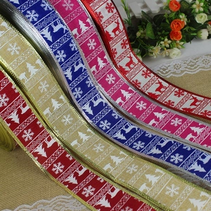 Detail of Christmas faux linen ribbons with reindeer and snowflake patterns for gift wrapping