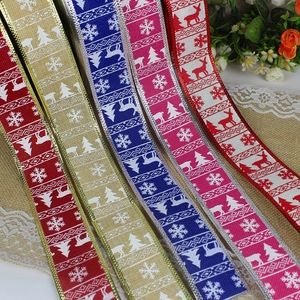 Detail of Christmas ribbons with reindeer and snowflake patterns for gift wrapping