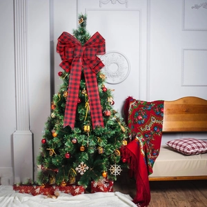 Christmas tree topper with red and black buffalo plaid ribbon bow for holiday decoration