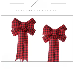 Detailed view of two Christmas buffalo plaid bows with long ribbons for tree decoration