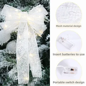 Close-up of LED Christmas bow showing mesh fabric with stars and battery pack