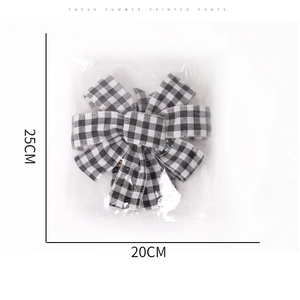 Detailed view of a 25x20cm buffalo plaid Christmas bow for tree and wall decoration