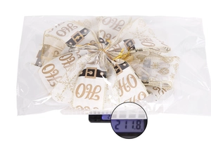 Macro weight measurement of the white mesh Christmas bow with golden snowflakes and Ho Ho Ho text