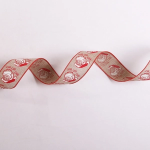 Close-up of Ho Ho Ho Santa Claus pattern burlap ribbon with festive red stitched edges