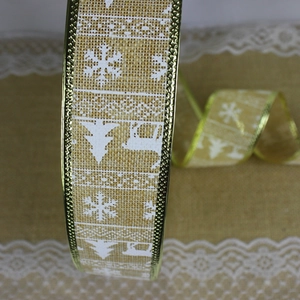 Detail of Christmas faux linen ribbon with white reindeer and snowflake prints