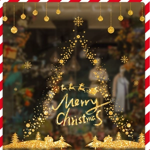 Detail of golden glitter Christmas window sticker featuring a tree silhouette and reindeer