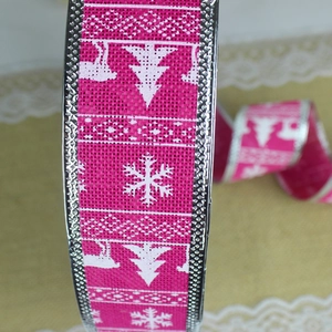 Close-up of pink faux linen Christmas ribbon with white reindeer and snowflake prints