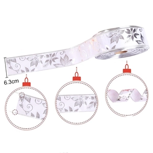 White 6.3cm Christmas ribbon with silver poinsettia print and elegant gold wired edges