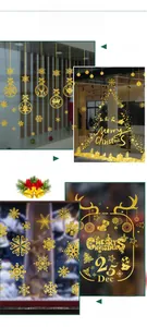 Detail of golden glitter Christmas window stickers with snowflakes and festive ornaments