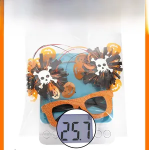 Detailed view of Halloween party glasses weighing 25.7g on a digital scale
