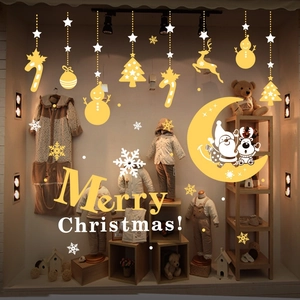 Macro view of Christmas window decals featuring Santa, reindeer and snowflakes on glass