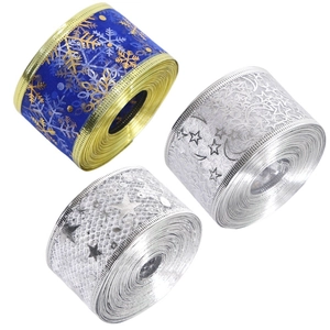 Three rolls of Christmas decorative ribbons with gold edges and snowflake star patterns