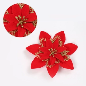 Detailed view of red velvet Christmas poinsettia with decorative gold glitter edges