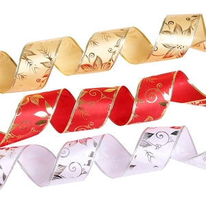 Close-up of gold, red, and white Christmas ribbons with elegant floral metallic patterns