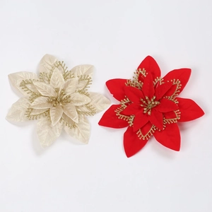 Detail of multi-layered red and beige velvet Christmas flowers with gold glitter edges