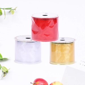 Close-up of semi-transparent red, gold and white organza ribbons for gift wrapping