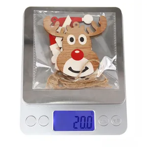 Detailed view of a wooden Christmas reindeer ornament on a scale weighing 20.0 grams