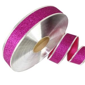 Close-up of magenta glitter ribbon with silver wire edge for gift wrapping decoration