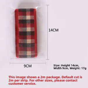 Detail view of 2M red and black Scottish plaid ribbon roll in transparent packaging