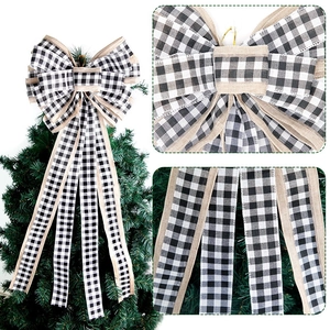 Detail of burlap and black white plaid Christmas bow with long ribbons on tree