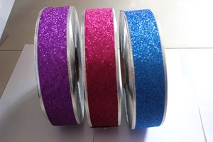 Detail of multi-color glitter ribbons in purple, pink, and blue for gift wrapping