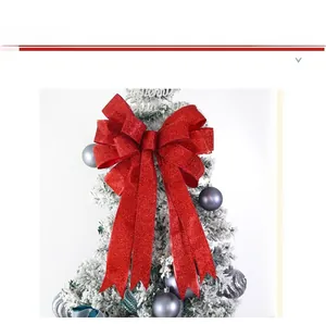 Detailed view of dual-layer red glitter bow ornament on a white decorative Christmas tree