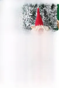Detail of Christmas tree decoration dolls with felt hats and heart patterns in holiday scene