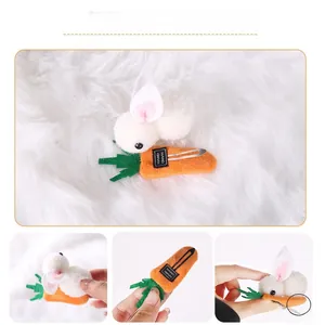 Close-up of handmade plush bunny on carrot hair clip with metal alligator grip