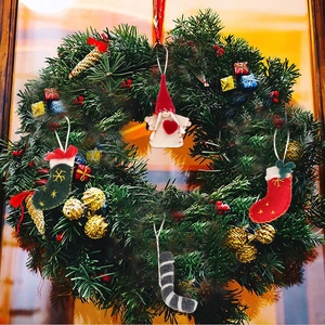 Detail of felt Christmas wreath with angel doll, stockings and gold pinecones