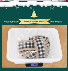 Detail showing the black and white plaid ribbon roll in packaging on a scale for weight check