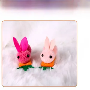 Detail showing two plush Easter bunny clips in deep and light pink with carrot base
